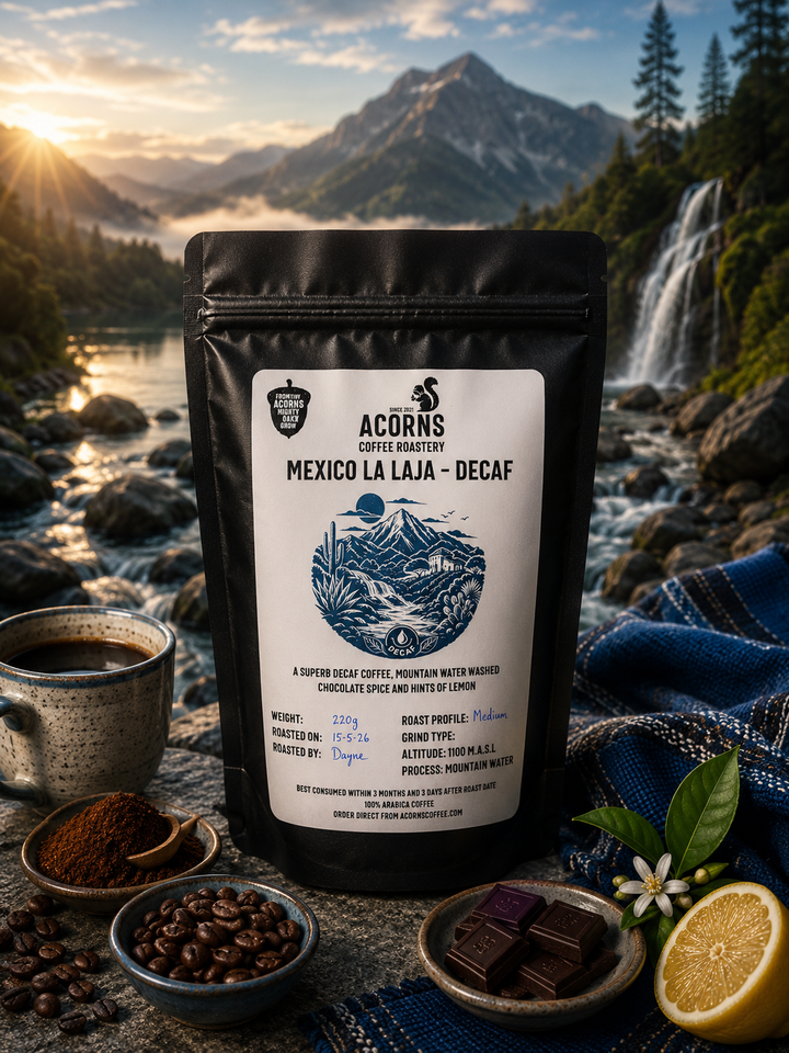 Acorns Coffee Roasters Mexico La Laja Decaf package with a scenic background of mountains and waterfalls.